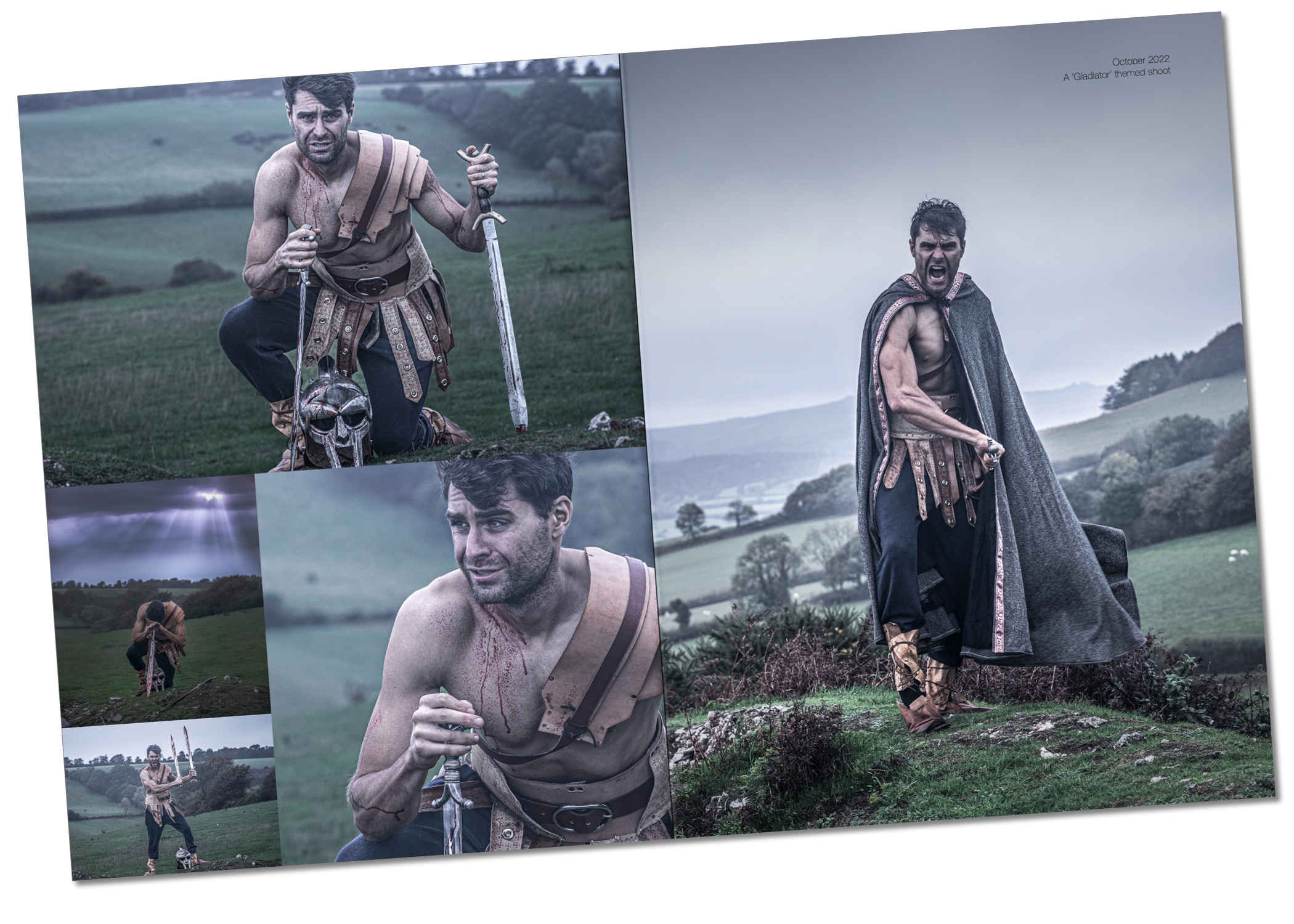 Ed Akay in a gladiator-themed photoshoot on the moors, October 2022. Four images on the left show Ed in action poses wearing ragged leather boots, dark trousers, leather shoulder armour, and a grey wool cloak with decorative edging, wielding Celtic swords. The right-hand image is a full-page portrait with distance fog on the hills, Ed unshaven and battle-haggard with a replica gladiator helmet. Muted, bleak colors and overcast light convey the atmosphere of the grey day.