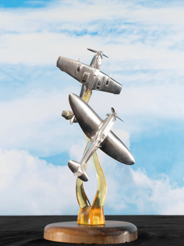 Second view of aluminium sculpture showing Battle of Britain 1940, featuring Spitfire and Bf 109 fighters in dynamic aerial combat scene.