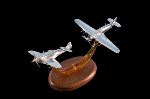 Aluminium sculpture of Burma 1944 aerial combat, displaying Hawker Hurricane and Nakajima Ki-44 Shōki fighter aircraft from World War II.