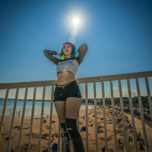 Alternative female model poses in artistic shot at Torquay Beach footbridge