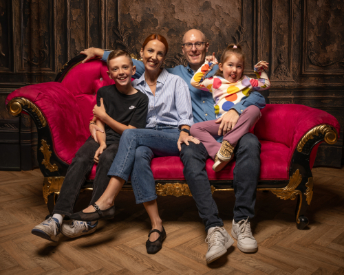 Family portrait of parents with their son and daughter taken at a 90th birthday celebration photoshoot.